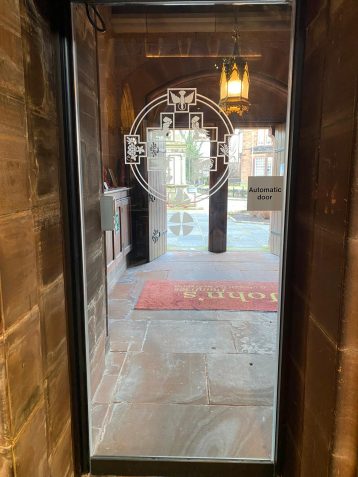 A glass door with a circular design on it
AI-generated content may be incorrect.